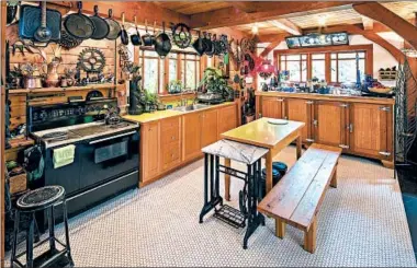  ?? MIKE SIEGEL/SEATTLE TIMES PHOTOS ?? Daucey and Pat Brewington’s home outside North Bend, Wash., features a mahogany fixture (far end of the kitchen under the window) in the kitchen, which is an old beer cooler from a defunct Queen Anne Hotel.