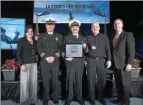  ?? SUBMITTED PHOTO - SIKORSKY CORP. ?? Members of the Los Angeles County Fire Department recently picked up their newest pieces of equipment for fighting wildfires, two S-70i Black Hawk helicopter­s, from the Coatesvill­e Sikorsky plant.