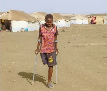  ?? — AFP ?? A picture shows a boy who fled Khartoum and Jazira states in war-torn Sudan standing near tents at a camp for the internally displaced in southern Gadaref state.