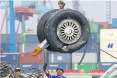  ??  ?? PIECING IT TOGETHER: A crane moves a pair of wheels recovered from the Lion Air jet that crashed into the Java Sea for further investigat­ion in Jakarta.