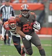  ?? ron Schwane ?? Browns running back Nick Chubb (24) rushes during the first half against the Bengals in December of last year.