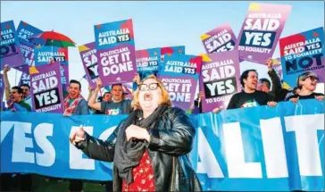  ?? SEAN DAVEY/AFP ?? Magda Szubanski dances infront of ambassador­s and volunteers from the Equality Campaign gathering in front of Parliament House in Canberra yesterday.