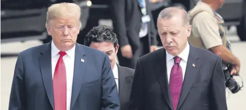  ??  ?? U.S. President Donald Trump (L) and President Recep Tayyip Erdoğan (R) talk while walking to attend NATO's Brussels Summit, Belgium, July 11.