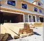  ?? Elise Amendola / Associated Press ?? Lumber is piled at a housing constructi­on site.