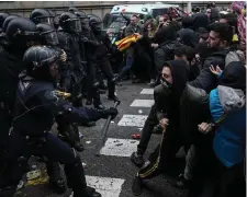  ??  ?? Police in Barcelona clash with protesters after the arrest of Carles Puigdemont in Germany