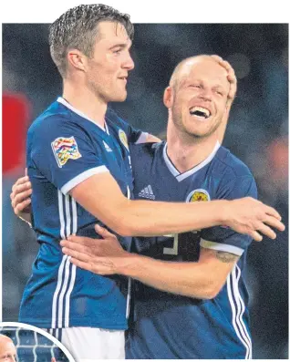  ??  ?? Steven Naismith and Hearts team-mate John Souttar were smiling at Hampden last Monday, while (inset) Naismith celebrated grabbing Scotland’s second goal against Albania