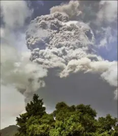  ?? Orvil Samuel/Associated Press ?? Plumes of ash rise from the La Soufriere volcano as it erupts on the eastern Caribbean island of St. Vincent, as seen from Chateaubel­air on Friday.