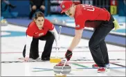  ?? NATACHA PISARENKO / ASSOCIATED PRESS ?? The United States’ Matt Hamilton sweeps the ice as his teammate and sister Becca watches during a mixed doubles curling match.