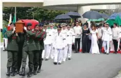  ??  ?? MANILA: This handout photo taken on November 18, 2016 and released by the office of Governor Imee Marcos shows military personnel carrying the coffin of the late dictator Ferdinand Marcos, while members of the Marcos family led by former first lady...