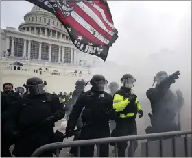  ?? JULIO CORTEZ — THE ASSOCIATED PRESS ?? Police hold off Trump supporters who tried to break through a police barrier Wednesday at the Capitol.