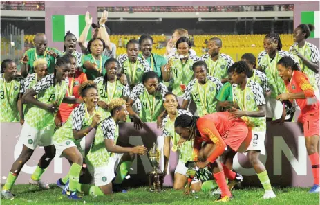 ??  ?? Players of Nigeria’s Super Falcons celebrate with the trophy after winning the Total Women’s Africa Cup of Nations, Ghana 2018