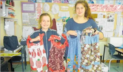  ??  ?? Year 10 students, Georgia Russell and Georgia Niblett holding finished dresses.