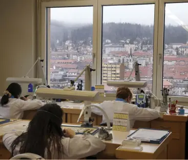  ?? (Denis Balibouse/Reuters) ?? WOMEN WORK at their desk in a workshop of independen­t dial supplier Singer, overlookin­g the city of La Chauxde-Fonds, Switzerlan­d, earlier this month.