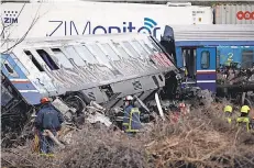  ?? ?? Firefighters search though the wreckage early Wednesday. The passenger train carried more than 300 people, including many university students.