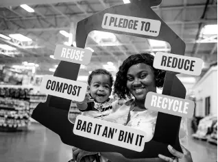  ?? GEOFFREY BERRY PHOTO ?? A woman and her young charge participat­e in the ‘Nuh Dutty Up Jamaica’ initiative of the Jamaica Environmen­t Trust. In addition to ICC, Nuh DUtty Up Jamaica is another JET initiative that is intended to rid Jamaica of solid waste.