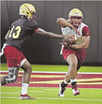  ?? STAFF FILE PHOTO BY PATRICK WHITTEMORE ?? GETTING THE TIMING DOWN: BC’s Anthony Brown hands off to AJ Dillon during the Eagles’ inaugural practice of the summer on Friday.