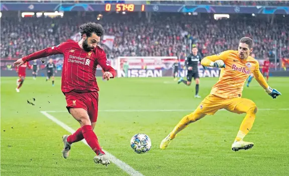  ?? Picture: PA. ?? Liverpool’s Mohamed Salah scores from the acutest of angles for Liverpool’s second in Austria last night.