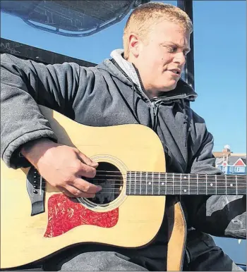  ??  ?? Harbour tour guide Simon LeBlanc is also a talented on-board musician. He sings a song while docked at the wharf.