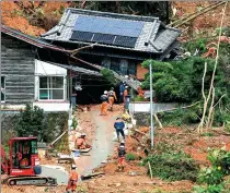  ?? THE ASAHI SHIMBUN VIA GETTY IMAGES ?? The rescue operation for missing residents continues after torrential rains triggered a landslide on Saturday in Ashikita, Kumamoto, Japan.