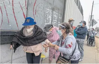  ??  ?? Elderly women queue for Covid vaccinatio­ns in the San Martin de Porres district of Lima, Peru.