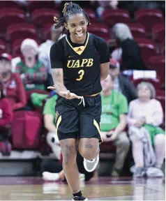  ?? (NWA Democrat-Gazette/Charlie Kaijo) ?? UAPB guard Demetria Shephard gestures after scoring a three pointer on Sunday, December 10, 2023, during the second half of a basketball game at Bud Walton Arena in Fayettevil­le.