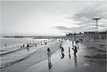  ?? MARK LENNIHAN, AP ?? Sundown attracts beachgoers in August at Brooklyn’s Coney Island in New York.