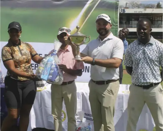  ?? ?? Ryan Cairns poses with his winner's trophy while Universal Sports Club official Akil Yousuf and ZPGA representa­tives Simon Chigorimbo (right) and Love Chingono (left) look on