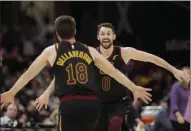  ?? TONY DEJAK - THE ASSOCIATED PRESS ?? Cleveland Cavaliers’ Kevin Love, right, and Matthew Dellavedov­a celebrate after Love made a three-point shot in overtime in an NBA basketball game against the San Antonio Spurs, Sunday, March 8, 2020, in Cleveland. The Cavaliers won 132-129 in overtime.