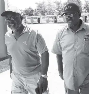  ?? JERMAINE BARNABY/FREELANCE PHOTOGRAPH­ER ?? Member of Parliament Fitz Jackson (left) with his People’s National Party Comrade, Councillor-elect Gary Nicholson, making their way on to the Ascot Primary School premises for the Greater Portmore North by-election, which Nicholson won yesterday.