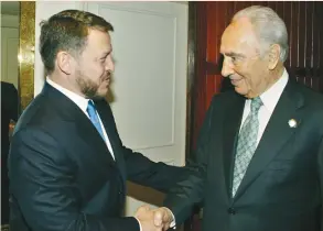  ?? (Yousef Allan/Reuters) ?? KING ABDULLAH welcomes Shimon Peres at the Nobel laureates meeting in Petra, Jordan, on May 18, 2005.