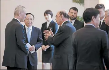 ?? ANDY WONG/AP ?? Commerce Secretary Wilbur Ross, center, chats Sunday with Chinese Vice Premier Liu He, left, after their Beijing meeting.