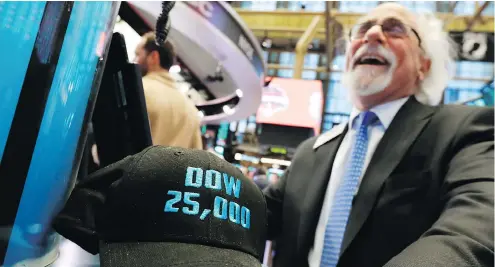  ?? RICHARD DREW / THE ASSOCIATED PRESS FILES ?? Trader Peter Tuchman with an old “Dow 25,000” hat at the NYSE on Jan. 30. The bull market started with the economy reeling in March 2009.