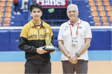  ?? ?? Negrense Joncriz Ayco of the University of Santo Tomas Junior Golden Spikers receives his MVP trophy.