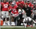  ?? JAY LAPRETE — THE ASSOCIATED PRESS ?? Ohio State receiver Parris Campbell escapes the grasp of UNLV linebacker Gabe McCoy on his way to scoring a touchdown during the first half.