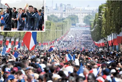  ??  ?? Supporters gather on the Champs-Elysees avenue near the Arc de Triomphe in Paris yesterday as they wait for the arrival of the French national team for celebratio­ns after it won the World Cup by beating Croatia 2-1 in the final in Moscow on Sunday. (Inset) Goalkeeper Hugo Lloris holds the trophy as he and teammates arrive at Charles de Gaulle Airport in Paris yesterday. — AFP/Reuters