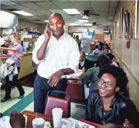  ??  ?? Shelby County mayoral candidate Lee Harris, top, chats with lunchtime customers at Miss Girlies on Chelsea Avenue during a recent campaign stop. MARK WEBER/THE COMMERCIAL APPEAL