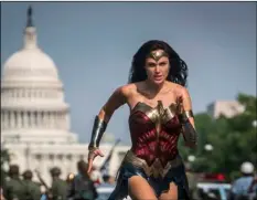  ?? Clay Enos/Warner Bros Pictures via AP ?? This image released by Warner Bros. Pictures shows Gal Gadot as Wonder Woman in a scene from “Wonder Woman 1984.” The film isn’t skipping theaters or moving to 2021, but it is altering course.