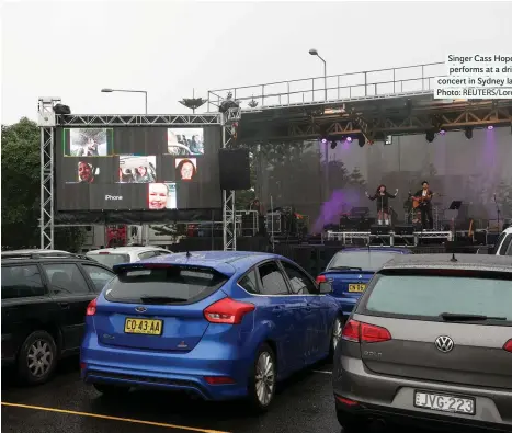  ??  ?? Singer Cass Hopetoun performs at a drive-in concert in Sydney last week Photo: REUTERS/Loren Elliott