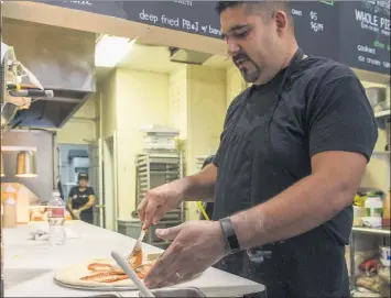  ?? SCNG FILE PHOTOS ?? Chef Michael Martinez prepares food on Nov. 8, 2017, in 5000Pies, a service of the Fountain of Life Covenant Church in Long Beach. The kitchen provides culinary training and life skills coaching to young adults.