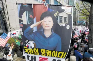  ?? Picture / AP ?? Supporters of Park Geun Hye called for her release as they protested near the court in Seoul where her sentence was handed down yesterday.