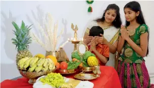  ??  ?? A Malayalee mother makes sure her children see the Vishukkani as the first sight in the day.