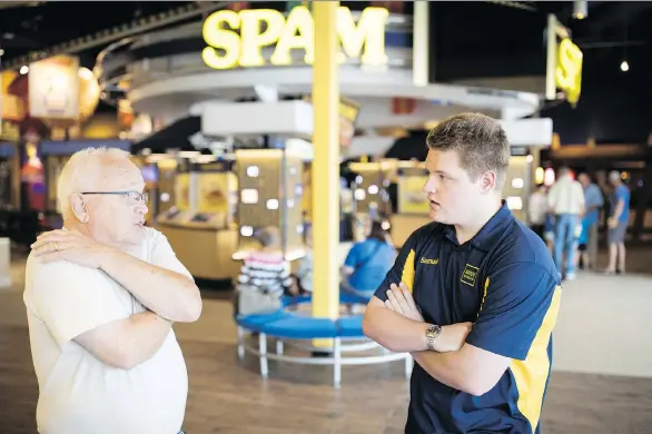  ?? PHOTOS: JENN ACKERMAN/THE WASHINGTON POST ?? “Spambassad­or” Samuel Ehret, right, who has autism, answers a guest’s questions at the Spam Museum in Austin, Minn. The town’s ongoing autism-friendly efforts have encouraged schools, businesses and residents to accommodat­e people on the spectrum through a variety of programs.