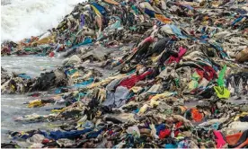  ?? Photograph: Muntaka Chasant/REX/Shuttersto­ck ?? Discarded secondhand clothes cover the beach in the fishing community of Jamestown in Accra, Ghana.