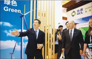  ?? Associated Press ?? Gov. Governor Jerry Brown, right, is shown an exhibition at an internatio­nal clean energy conference in Beijing on Wednesday. With President Donald Trump pulling the U.S. out of the Paris climate accord, China and California signed an agreement Tuesday to work together on reducing emissions, as the state’s governor warned that “disaster still looms” without urgent action.