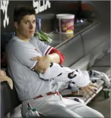  ?? CHARLES REX ARBOGAST — THE ASSOCIATED PRESS ?? Phillies starter Jerad Eickhoff keeps his arm wrapped in the dugout during the fifth inning on Wednesday, in Chicago. Eickhoff earned his ninth win of the season.