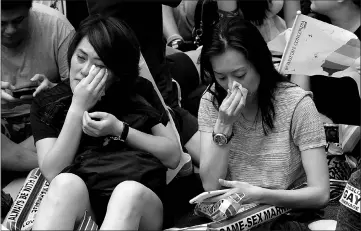  ??  ?? Same-sex activists are brought to tears outside the parliament in Taipei on May 24 as they celebrate the landmark decision paving the way for the island to become the first place in Asia to legalise gay marriage. — AFP photos