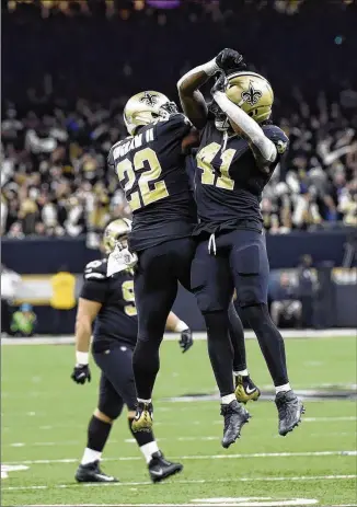  ?? BILL FEIG / ASSOCIATED PRESS ?? New Orleans’ Alvin Kamara (41) celebrates his 2-yard TD run in the fourth quarter with fellow Saints running back Mark Ingram (22). Kamara’s score with 5:08 left was Saints’ final TD.