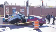  ?? ADOLPHE PIERRE-LOUIS/JOURNAL ?? Albuquerqu­e police officers investigat­e a crash that sent a vehicle spinning into an ART bus platform Wednesday morning. The driver of that vehicle died at the scene.