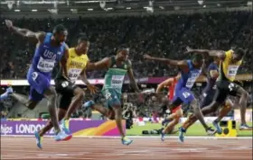  ?? MATT DUNHAM — THE ASSOCIATED PRESS ?? Justin Gatlin, center, wins the men’s 100-meter dash at the World Athletics Championsh­ips in London on Saturday.