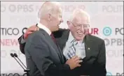  ?? Brian van der Brug Los Angeles Times ?? BERNIE SANDERS and Joe Biden embrace at the Democratic candidate debate in L.A. on Dec. 19.